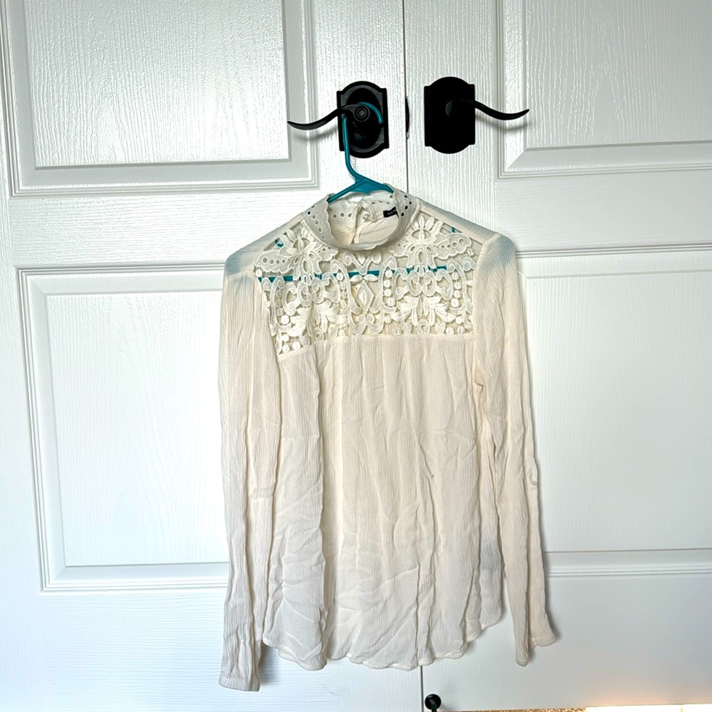 Long sleeve off white blouse.  Feminine flare.